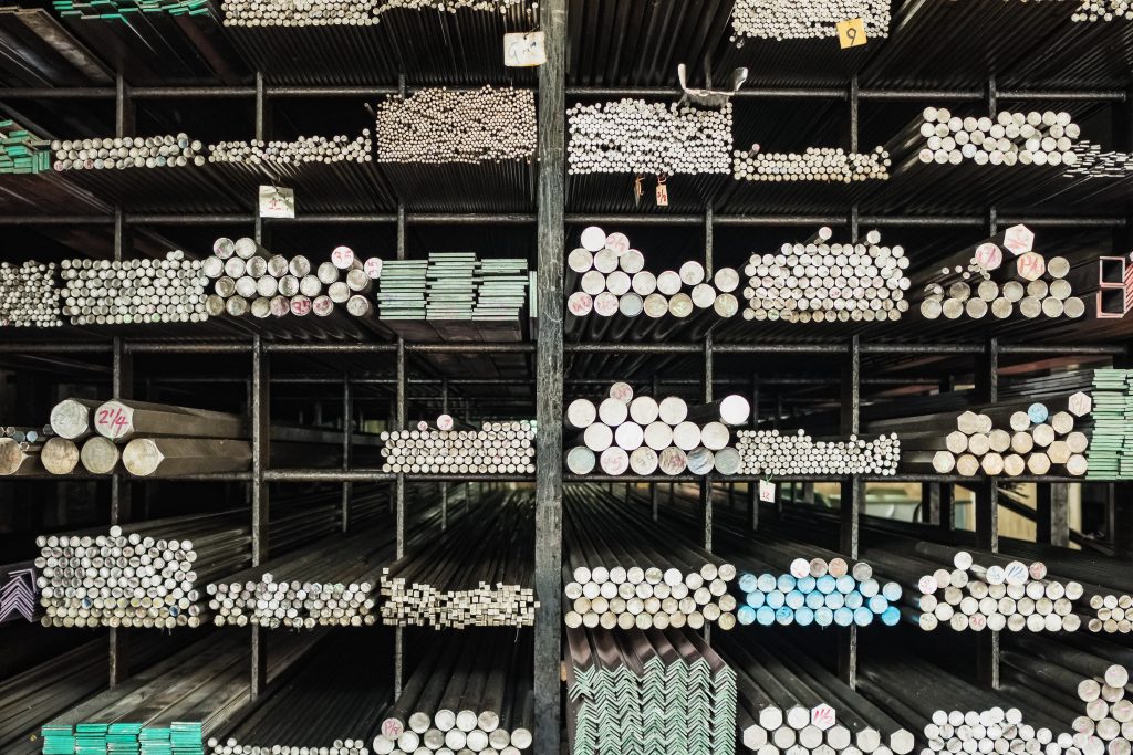 The building material and different sizes metal rodes and pipes stacked in shop
