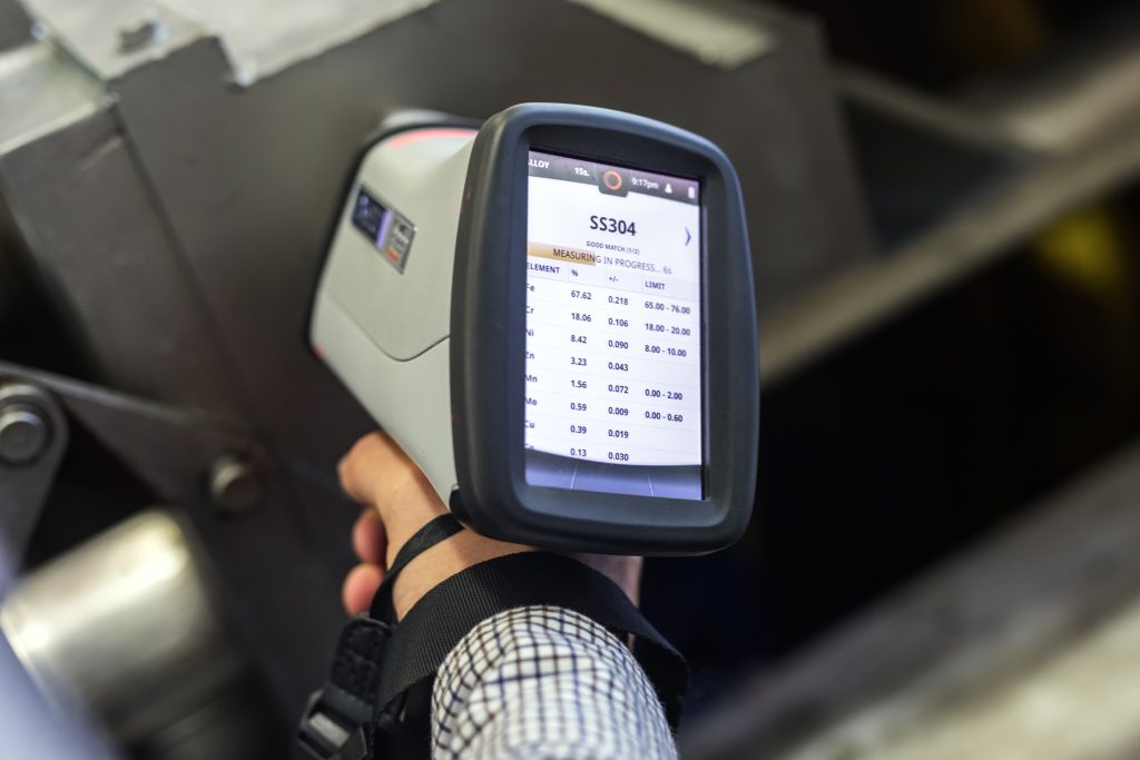 The inspector is material analysis (pmi and xrf) is measuring in stainless steel (ASTM A 304-SS304 material) with digital portable material analyzer.